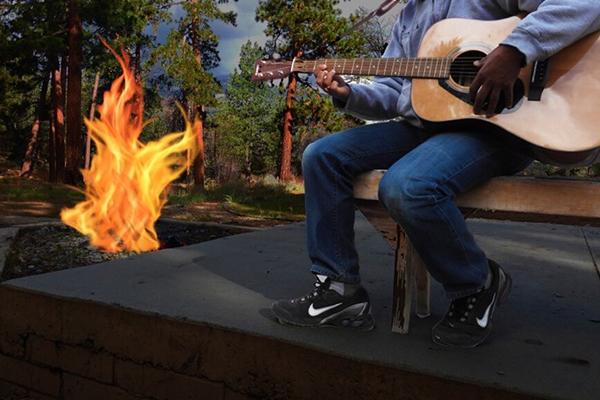 Guitar player by campfire.jpg